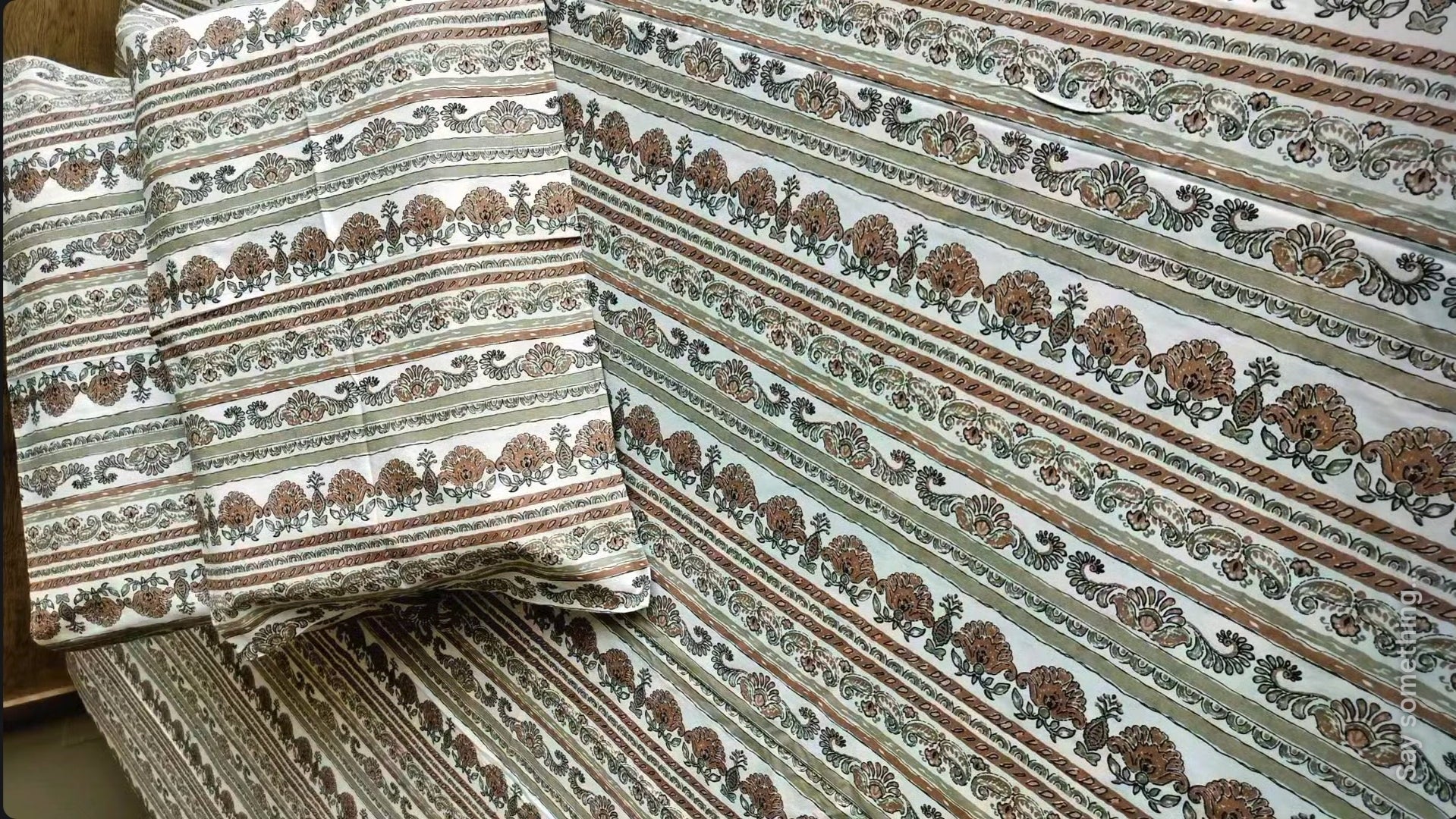 Patterned fabric with stripes and floral designs on a plain background